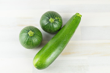 Varieties of green zucchini on wooden table
