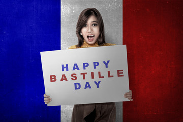 Attractive asian woman with board with Bastille day message