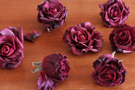 Withered roses on a wooden table. Flowers