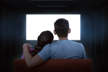 Portrait of asian couple sitting on couch watching blank tv