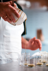 Confectioner preparing cream in pastry shop, food industry