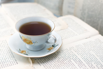 cup of coffee on paper sheets background