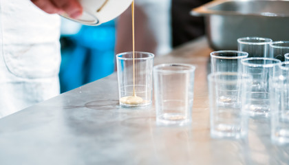 Confectioner preparing cream in pastry shop, food industry