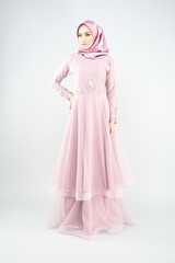 Beautiful muslim girl wearing pink asian dress known as Baju Kurung with Hijab.Hijab fashion for Eid Mubarak.Studio Shoot.