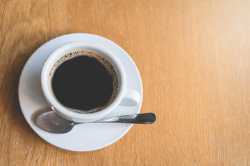 Obraz na płótnie Canvas Coffee white cup , Black coffee on wood table ,warm and good smell
