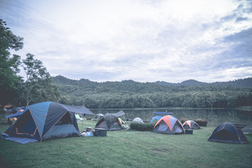 Tourists tent camping beside a lake in a national park, Thailand