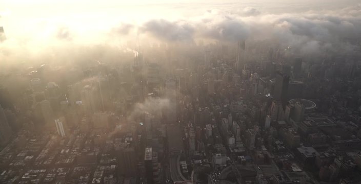 New York City aerial view of Midtown Manhattan from Hell's Kitchen during sunrise with fog and low level clouds.
