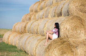 Girl resting on straw bale