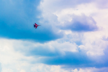 Fototapeta na wymiar Military aircraft in a beautiful sky with clouds