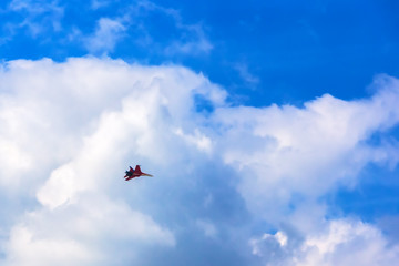 Fototapeta na wymiar Military aircraft in a beautiful sky with clouds