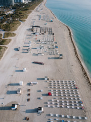 Fototapeta premium Aerial view of sandy beach with sun loungers, Miami Beach, Florida, USA