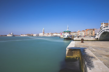 Obraz premium Long exposure view of the blue turquoise lagoon of Venice with the Campanile in the background, Venice, Italy