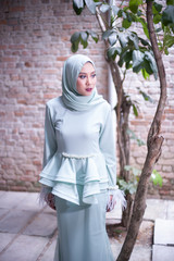 Fototapeta na wymiar Eid ul-Fitr fashion portraiture.Beautiful muslim girl wearing asian dress with hijab.Hijab Fashion outdoor Portraiture.