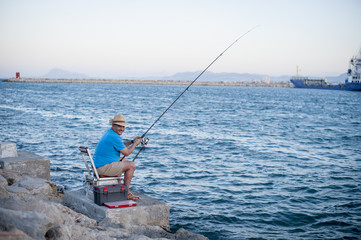 Fototapeta na wymiar Mature Man Fishing in the Sea