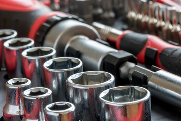 a set of metal heads with bit of key and screwdriver inside tool box.