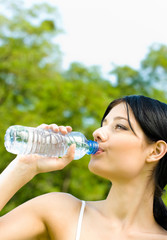 Portrait of woman drinking water outdoor