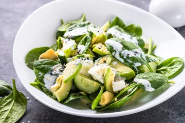 Fototapeten Green salad with avocado, spinach egg and cucumber. © nadianb