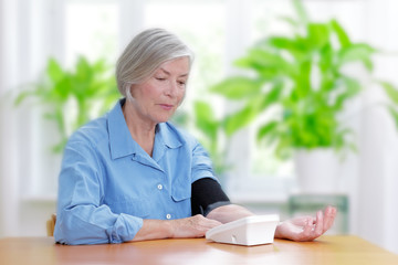 senior woman measuring blood pressure