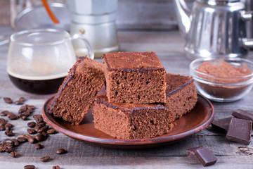Homemade brownies on plate on wood table.