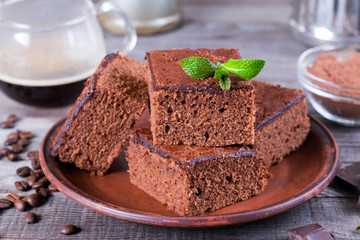 Homemade brownies on plate on wood table.