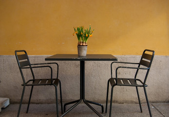 Characteristic Italian restaurant with chairs and table outside