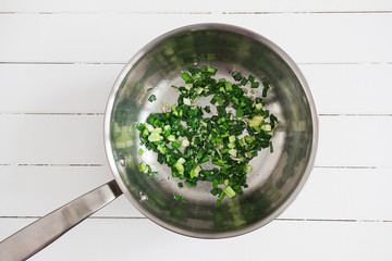 Scallions garlic ginger saute pan wooden background.