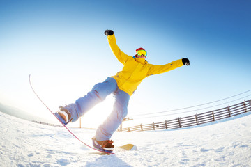 Snowboarder having fun jumps ski resort