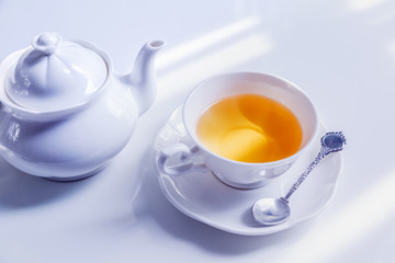 hot tea pouring into white cup, ready to drink