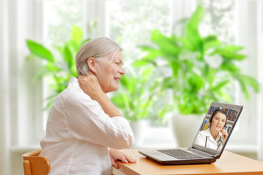 Senior woman with acute neck pain in front of a laptop making a video call with a specialist in orthopedics.