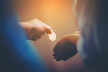 Golden Bitcoin in a man hand, Digitall symbol of a new virtual currency