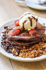 chocolate pancake with vanilla icecream,topping with strawberry and cereal