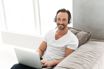 Attractive mature man listening to music
