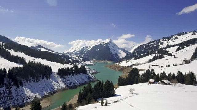 Stunning Drone footage over the mountains and  l.ake Hongrin in Vaud, Switzerland. The reservoir  is located in the municipalities of Château-d'Œx and Ormont-Dessous. 