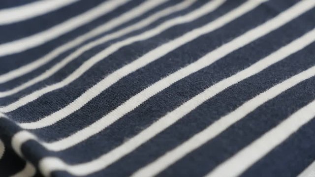 Slow tilt on sailor marine cloth footage - Details of striped blue and white fabric