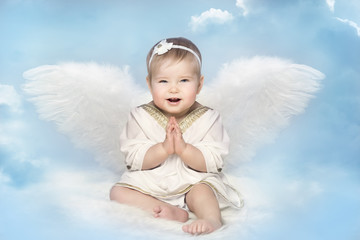 Angel Baby with Amur Wings, Kid Cupid Sitting on Blur Sky, Happy Girl Child Portrait
