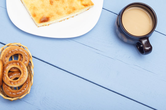 Sweet appetizer from delicious portion sweet dessert. Hot tea or coffee and cnack on white plate and on wooden table