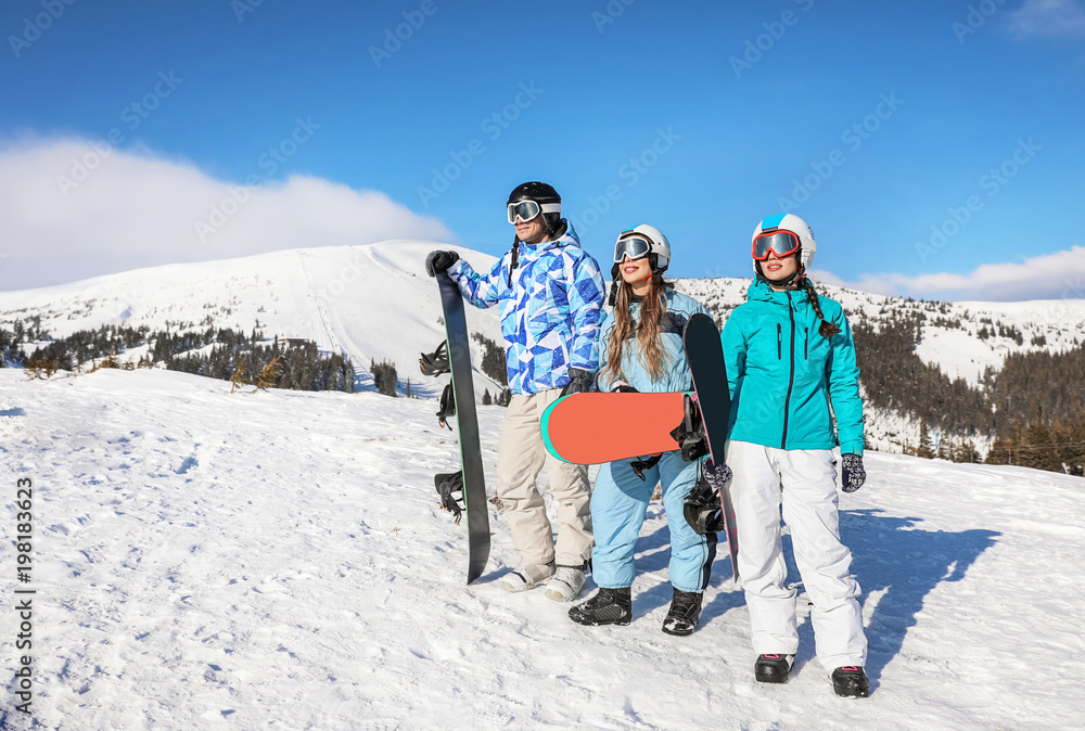 Sticker Group of snowboarders on ski piste at snowy resort. Winter vacation