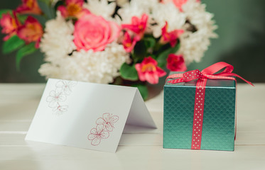 Love background with pink roses, flowers, gift on table