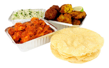 Chicken curry take away meal with rice and poppadoms in foil containers isolated on a white background