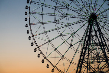 Ferris wheel silhouette against the sunset to use as background.