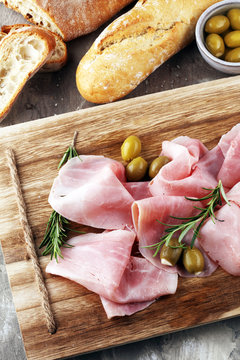 Sliced ham on wooden board. Fresh prosciutto. Pork ham sliced.