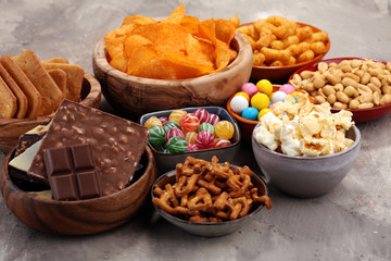 Salty snacks. Pretzels, chips, crackers in wooden bowls.