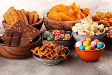 Salty snacks. Pretzels, chips, crackers in wooden bowls.
