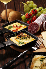 Delicious traditional Swiss melted raclette cheese on diced boiled or baked potato.