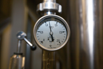 Pressure gauge (manometer) of white metal -  brewing equipment. Close-up, macro.