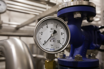 Pressure gauge (manometer) of white metal -  brewing equipment. Close-up, macro.
