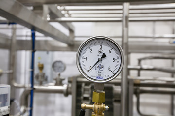 Pressure gauge (manometer) of white metal -  brewing equipment. Close-up, macro.