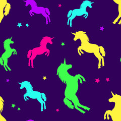 Seamless pattern with colorful silhouette unicorns on dark purple background. Vector illustration