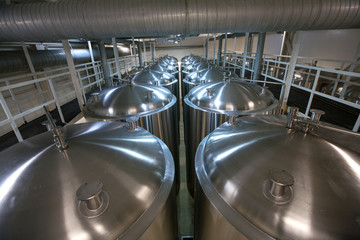 Huge Tanks of white metal, which brewed beer in the brewery, the top view
