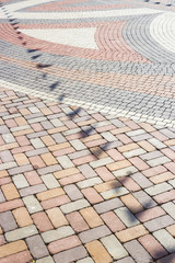 Reflection of triangular decorative flags on the paving slab. Shadow
